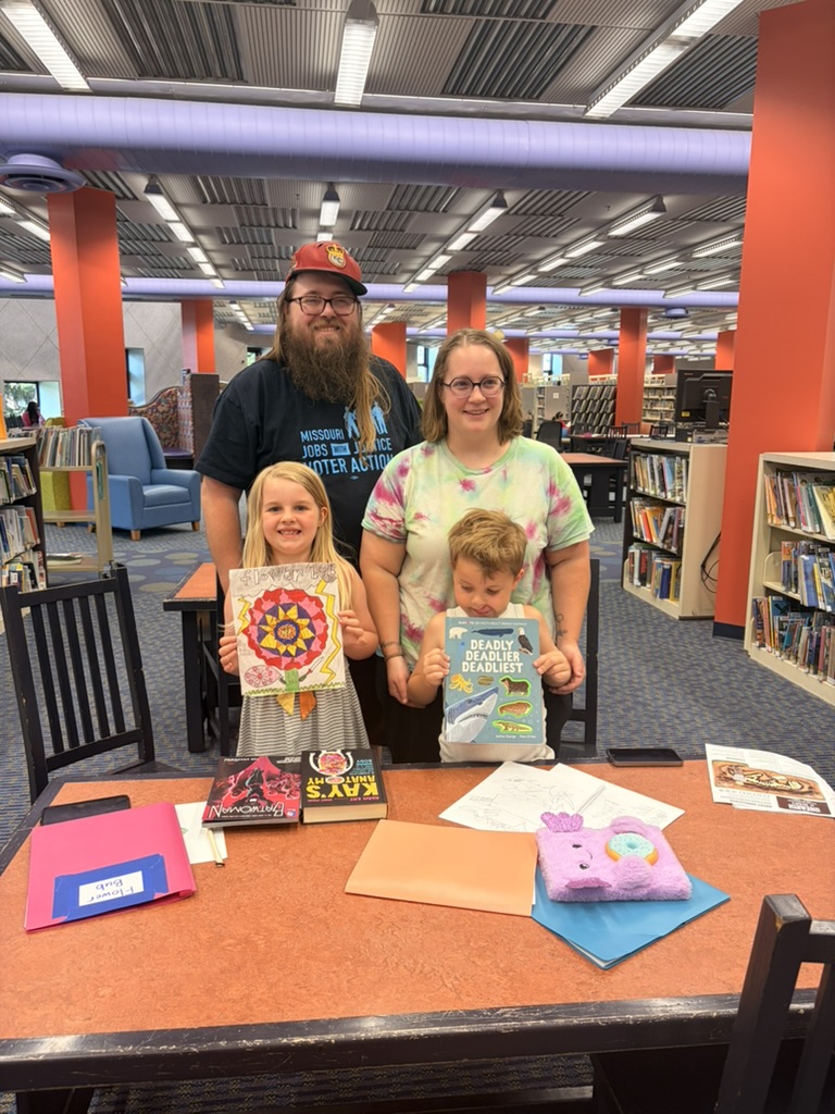 Young authors with their books at the library showcase